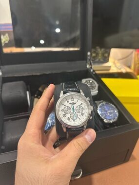 Silver Chronograph Wristwatch with White Dial and Black Leather Strap